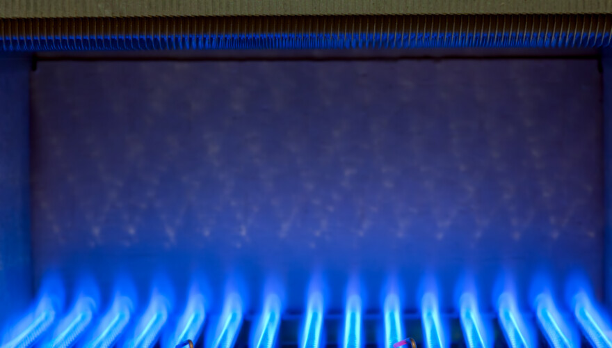 Natural gas burning inside a heat exchanger inside a gas-powered furnace