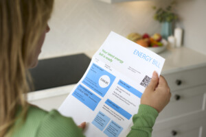 A woman reads her electricity bill