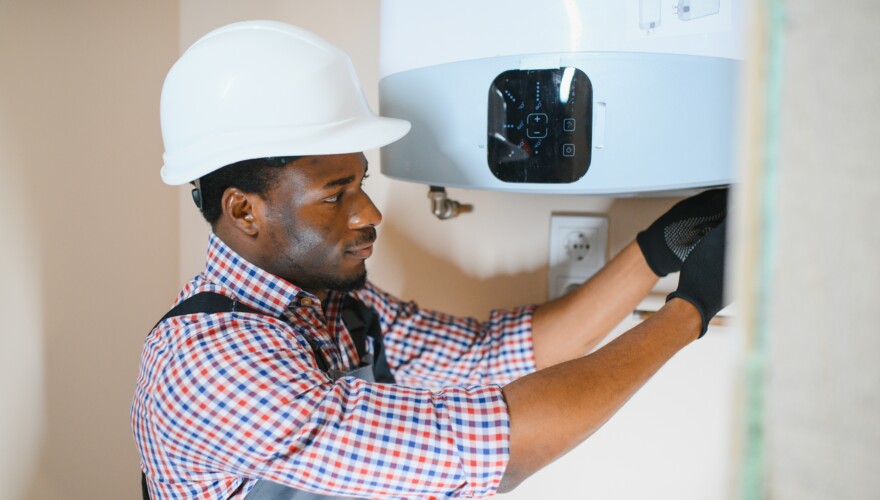 Efficient technician installing or inspecting a tankless water heater to ensure optimal performance and energy savings for residential heating needs.