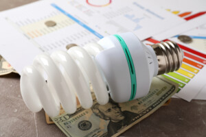 Energy saving concept on gray textured background.