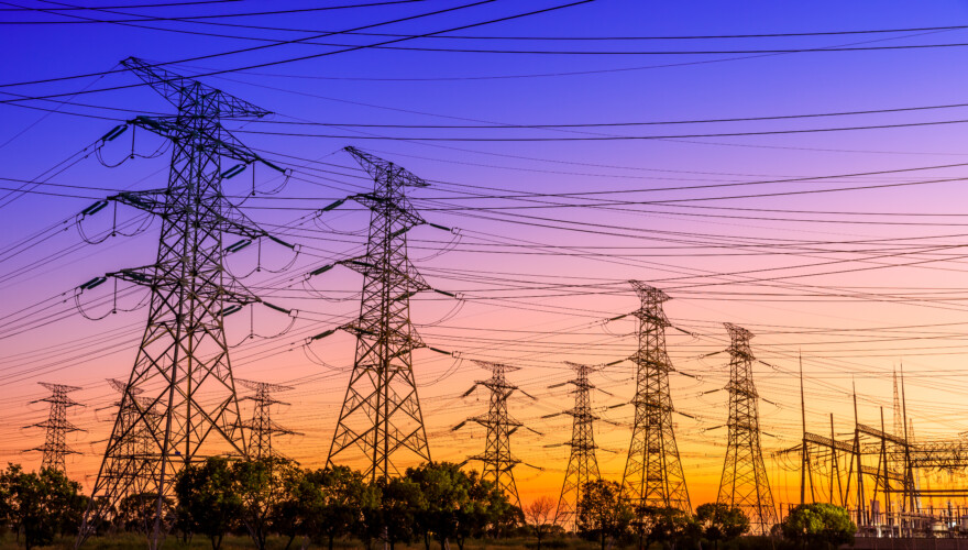A row of power lines at sunset