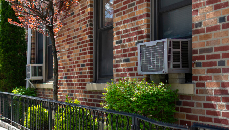 Outdoor Window Air Conditioning Units on an Old Brick Apartment Building during Spring