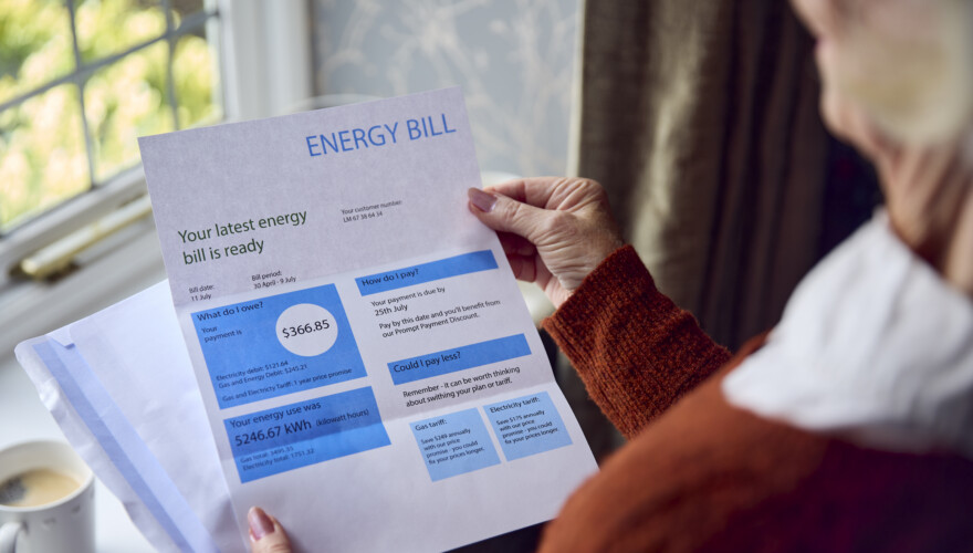 Close Up Of Senior Woman Opening an Energy Bill