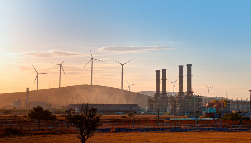 Silhouette of Natural gas processing plant with Renewable energy wind turbines generating electricity