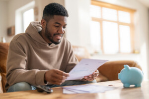 happy man reading his monthly natural gas bill