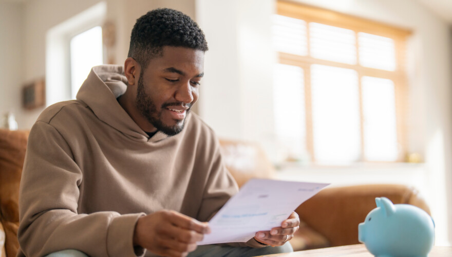 happy man reading his monthly natural gas bill