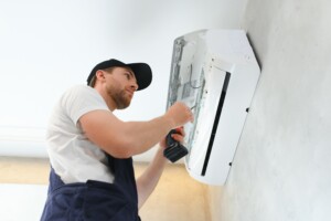 Service man is installing an air conditioner
