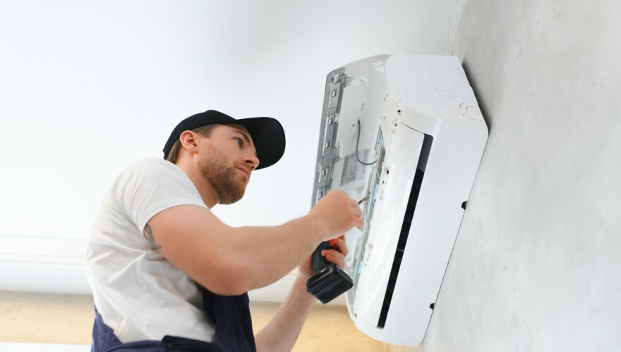 Service man is installing an air conditioner