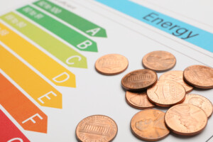 A closeup on coins on energy efficiency rating chart